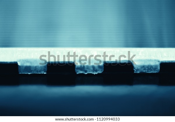 Detailed\
background of fragment of automotive radiator in macro with copy\
space. Monochrome image of metallic auto part is close-up. Empty\
surface of steel texture in blue\
tone.