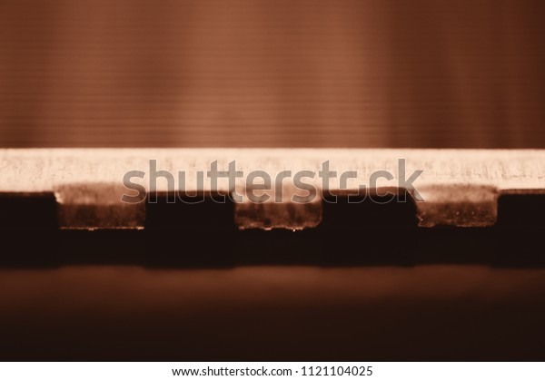 Detailed\
background of fragment of automotive radiator in macro with copy\
space. Monochrome image of metallic auto part is close-up. Empty\
surface of steel texture in brown\
tone.