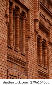 Detailed brickwork pattern with pilasters and corbels on historic wall
