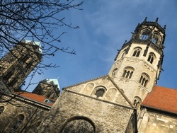 The Detailed Church Of St Ludgeri At A Skew Angle, In The German City Of Münster, Against A Blue Sky.
