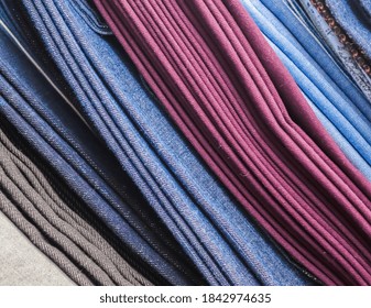 Detailed close up view on samples of cloth and fabrics in different colors found at a fabrics market.