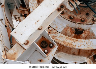 detailed close up vire of a white painted metal structure with rust