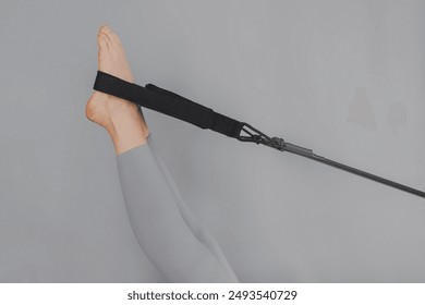 A detailed closeup of a foot work and core exercise on a Balanced Body Reformer machine illuminated by sunlight - Powered by Shutterstock