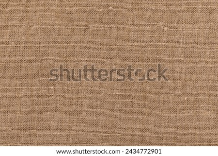 Detailed close-up of natural burlap fabric texture with woven pattern