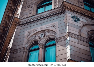 Detailed close-up of ornate stone carvings and arched windows on a historic building in Gothenburg, Sweden during spring. - Powered by Shutterstock