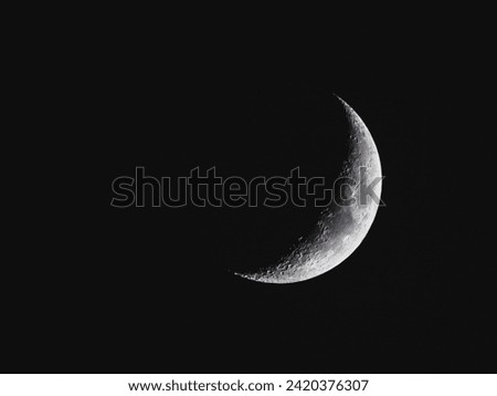 Detailed Crescent Moon in the night sky. Crescent Moon on black background with space for Ramadan theme.