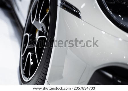 Detailed front view on wheels of white super sports car, modern luxury car.