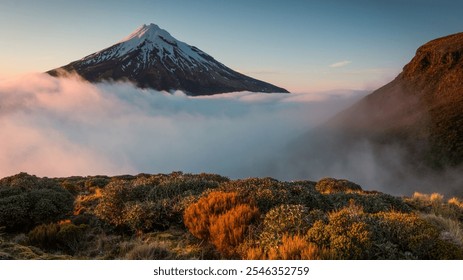 A detailed image of majestic mountain ranges with peaks and valleys covered in lush greenery and scattered forests. The scene features rocky cliffs and rolling hills, with mist clinging to valleys. - Powered by Shutterstock