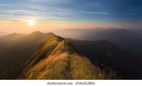 A detailed image of majestic mountain ranges with peaks and valleys covered in lush greenery and scattered forests. The scene features rocky cliffs and rolling hills, with mist clinging to valleys. - Powered by Shutterstock