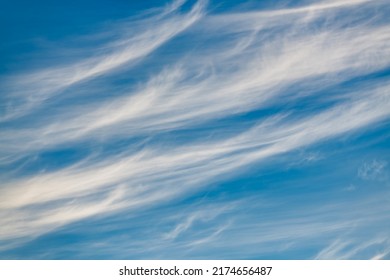 A Detailed Image Of White Wispy Cirrus Clouds Set Against A Blue Daytime Sky
