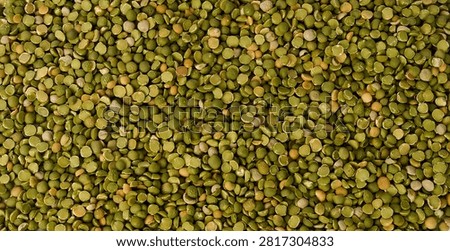  Detailed macro texture of dried split green peas filling the frame
                              