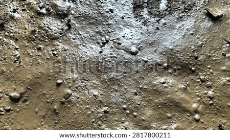 Detailed macro view of the ground surface: rough, dull and damp texture with dark brown nuances; wet, muddy and lumpy soil; muddy or muddy land that resembles a mud puddle