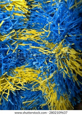 Detailed macro view of multicolored plastic bristles in image_4.png, highlighting strong primary colors, fine fiber detail, and an energetic abstract texture.