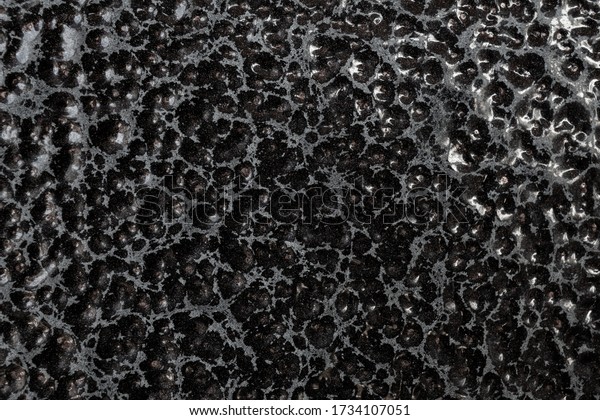 Detailed metal coating\
texture. Corrosion-resistant coating. Abstract background. A\
closeup. Dark colors. Background image. Space for text. Desktop\
wallpaper. Top view.