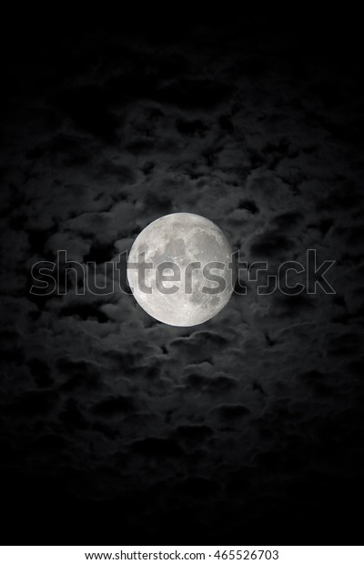 The\
detailed moon in background of the cloudy night\
sky