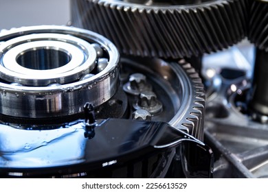 Detailed photo of an electric vehicle transmission. Main gears and ball bearing are highlighted, showcasing the technology behind the clean revolution. Selective focus