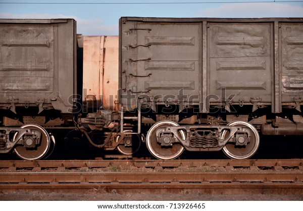 Detailed\
photo of railway freight car. A fragment of the component parts of\
the freight car on the railroad in\
daylight
