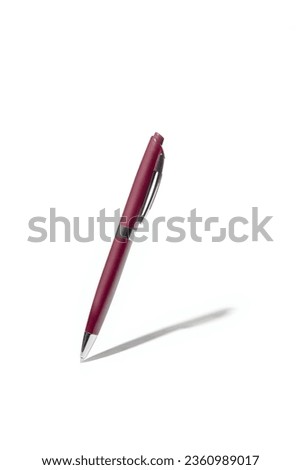 Detailed purple classic ballpoint pen writing on white surface with its shadow. Isolated on white background with clipping path