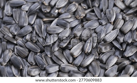 Detailed roasted sunflower kernel display, Macro shot of salted sunflower seeds surface, Highresolution image showcasing textured shells and kernels for food presentation