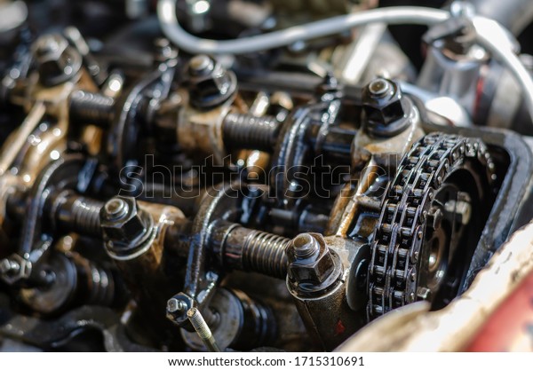 A detailed shot of the\
cylinder head of a carburetor engine. Four-stroke gasoline engine\
without cover. Gas distribution mechanism and chain\
close-up.