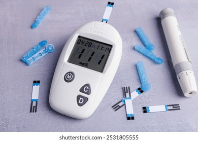 Detailed shot of a glucometer with test strips and lancets on a concrete table, highlighting the tools used for glucose testing and health monitoring - Powered by Shutterstock