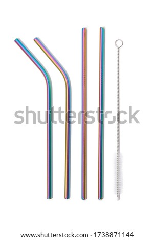 Detailed shot of iridescent reusable metal straws and a straw-cleaner. The set of eco-friendly cocktail straws is located on the white background.  