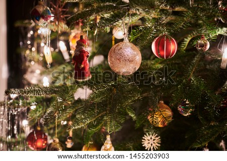detailed shot of some christmas decoration hanging on a christmastree