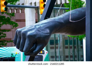 Detailed shot of the "The Fist" Joe Louis monument in Hart Plaza on Jefferson Avenue. This historic monument is a key attraction to downtown Detroit in the summer. Taken on a bright sunny day.