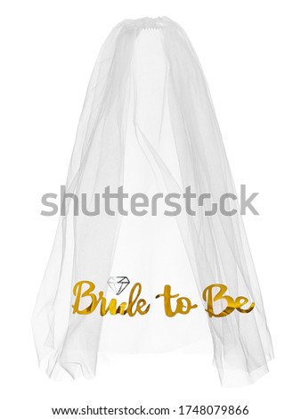 Detailed shot of a white mesh bride veil with golden lettering 