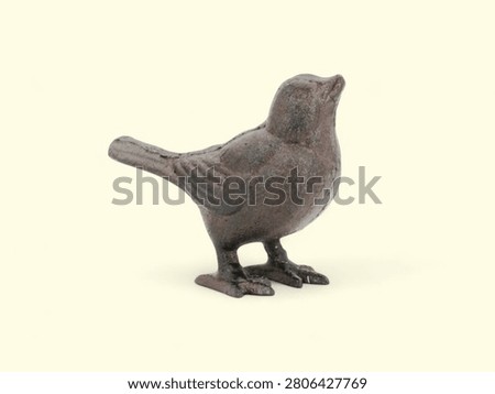 A detailed side view of a small gray bird standing on one leg against a plain white background.