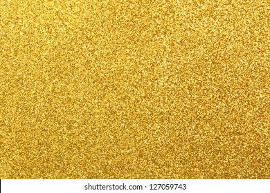 Detailed texture of glittering golden dust surface