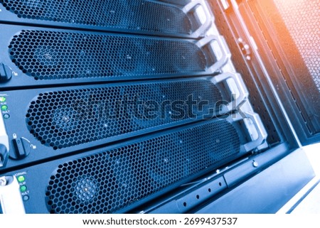 A detailed view of computer server hardware in a data center, showcasing cooling systems, network connections, and essential components for optimal performance.