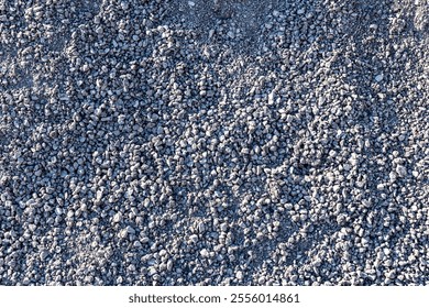 Detailed View of Fine Gravel Pebbles Spread Across a Construction Yard Surface - Powered by Shutterstock