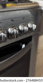 Detailed view of gas stove knobs in a modern kitchen setting.