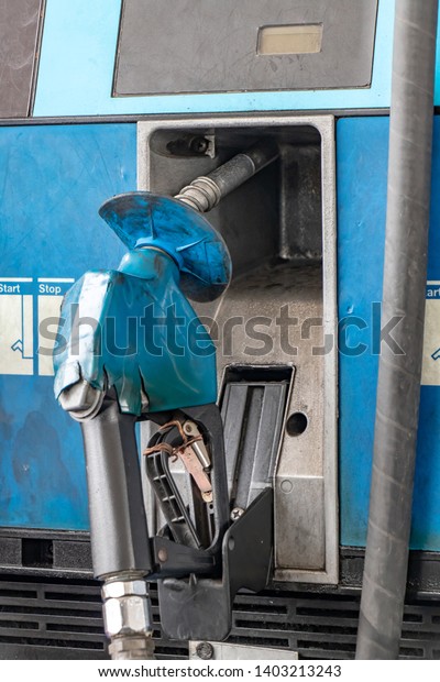  The detailed view of the handle of the\
pistol from the fuel pump. A gas\
station.