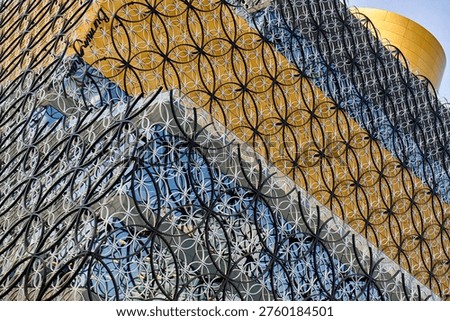 Detailed view of the interlocking metal circle pattern facade and gold rotunda of the Library of Birmingham, Centenary Square, Birmingham, West Midlands, England, UK, Europe.