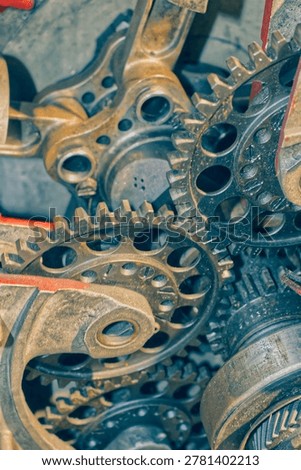 Detailed view of interlocking metal cogs and gears in a mechanical device. Industrial engineering