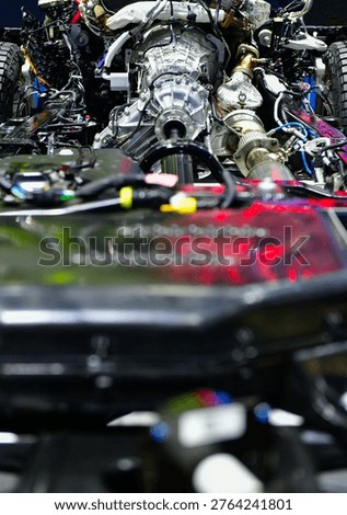 Detailed view of an internal combustion engine and 4x4 drivetrain mounted on a vehicle frame, showing mechanical components.