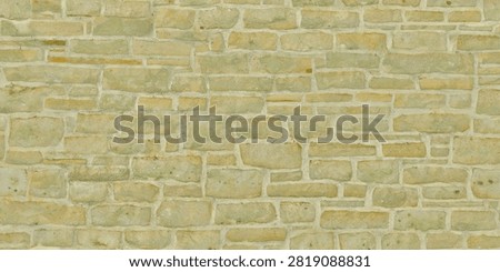 A detailed view of a light beige limestone wall with horizontal block pattern and light mortar.