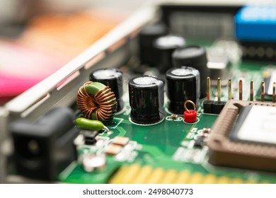 Detailed view of a modern electronic circuit board featuring capacitors, an inductor, and various components integrated for advanced technology products. For electronics projects, technology blogs