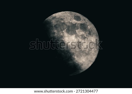 Detailed view of the Moon in partial phase against a dark night sky, showing lunar surface texture, craters, and natural light and shadow transition.