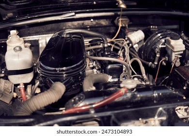 Detailed view of an old classic car engine with various parts and wiring under the hood - Powered by Shutterstock