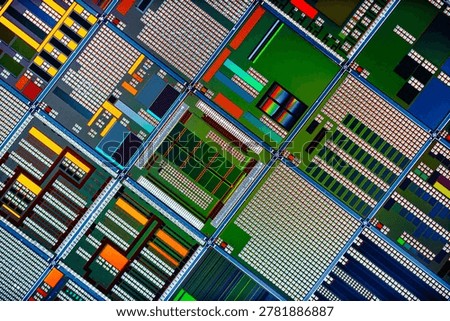 Detailed view of patterned silicon semiconductor wafer showing many integrated circuit dies in a geometric grid, colorful electronic texture for chip manufacturing and technology themes.