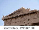 A detailed view of the pediment — the triangular upper part of the Parthenon’s facade — with sculptural elements reflecting ancient Greek art.