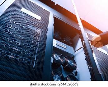A detailed view of a server rack featuring cooling fans and network equipment, highlighting the intricate technology used for data management and server operations. - Powered by Shutterstock - Get 15% off with code: PIKWIZARD15