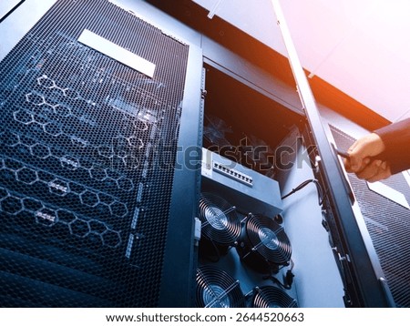 A detailed view of a server rack featuring cooling fans and network equipment, highlighting the intricate technology used for data management and server operations.