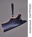A detailed view of a uniquely designed leather longbow quiver craftsmen. The item showcases intricate stitching and texture.