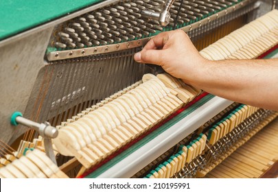 Detailed View Of Upright Piano During A Tuning