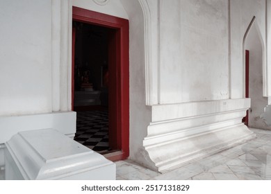 A detailed view of a white stone wall in a historic building with subtle architectural details. - Powered by Shutterstock