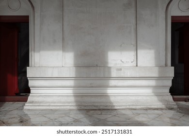 A detailed view of a white stone wall in a historic building with subtle architectural details. - Powered by Shutterstock